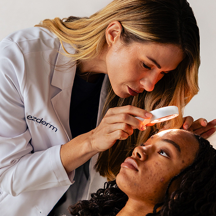 A dermatologist examining a patient using a dermatoscope.