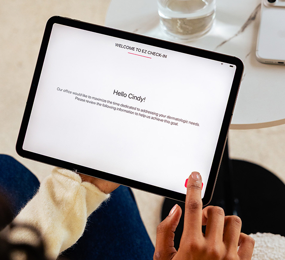 A patient is checking into her dermatology appointment using Ezderm's Ezcheck-in app.