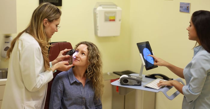 photo of Vaida Newara being examined at a dermatology practice