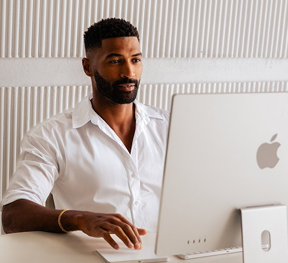 An Ezderm support team member is sitting in front of an computer.