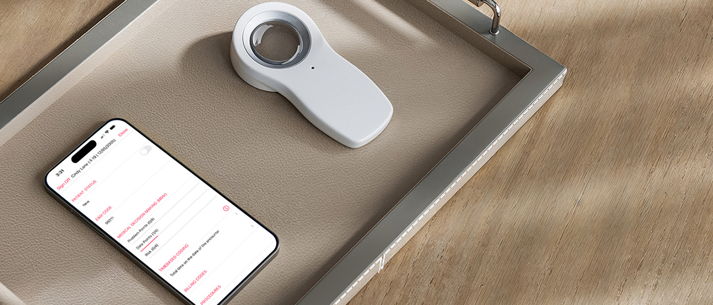 An iPhone featuring an encounter sign off screen and a dermatoscope on a tray in a dermatology office.