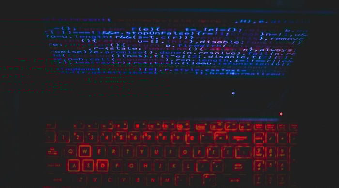 image of a computer backlit in red lighting